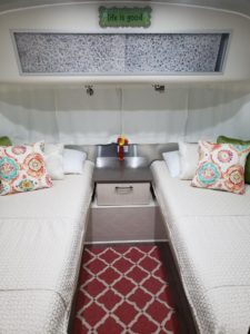 Final product Airstream Twin Bed Transformation. Two bed Airstream beds with decorative pillows.